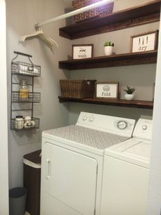 a washer and dryer in a laundry room with shelves above them that are filled with items