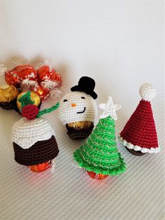 three crocheted christmas ornaments are sitting next to each other