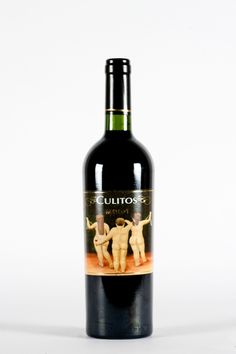 a bottle of wine that is sitting on a table next to a white background with an image of two nude men