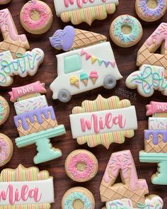 decorated cookies are arranged on a wooden table