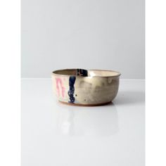 a white and blue bowl sitting on top of a table