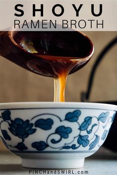 a spoon pouring caramel sauce into a blue and white bowl