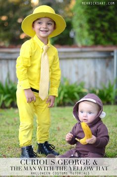 two young children dressed in yellow and wearing matching outfits, one is holding a banana