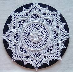 a white doily on a black plate