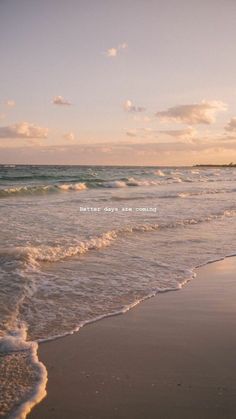 an ocean beach with waves coming in to shore