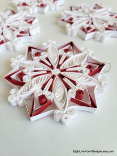 some red and white paper snowflakes on a table