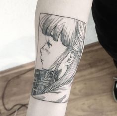 a woman's arm with a black and white drawing of a girl on it