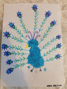 a blue bird is painted on a white paper