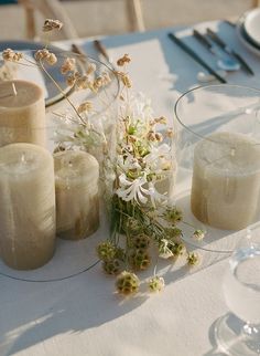 the table is set with candles and flowers