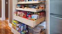 an organized pantry with pull out shelves and food items in the bottom drawer for storage