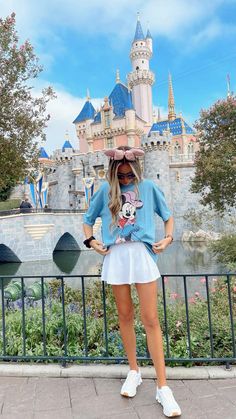 a woman standing in front of a castle