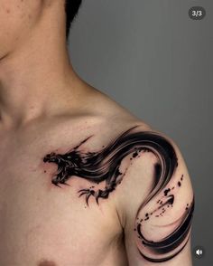 a man's chest with a dragon tattoo on his left shoulder and right arm