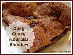 a close up of a plate of food with text overlay that reads ooey gooey flourless blondies