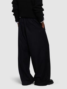 Elastic waistband. Model is wearing a sizeM Luxury Wide Leg Bottoms For Fall, Casual Wool High-waisted Pants, Wool Bottoms With Pockets, Tailored Wide-leg Pants With Elastic Waistband, Luxury Wide Leg Pants With Pockets, Luxury Wool Straight Leg Bottoms, Formal Wide-leg Pants With Elastic Waistband, Luxury Tailored Wide-leg Bottoms, Black Wool Wide-leg Bottoms