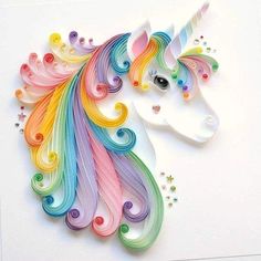 an image of a paper cut out of a unicorn's head with swirls and stars