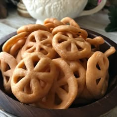 a bowl filled with pretzels sitting on top of a table