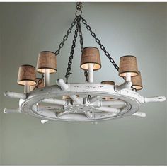 a chandelier made out of an old boat wheel with burlied lamps