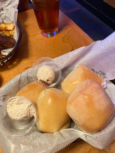 three rolls and some ice cream on a table next to a glass of tea or coffee