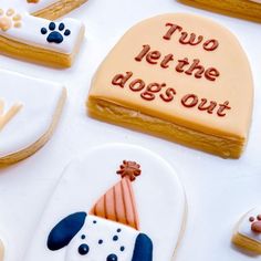 decorated cookies with dogs on them and saying two let the dogs out written in frosting