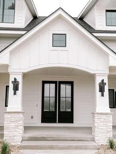 a white house with black doors and windows