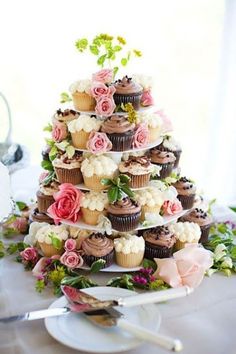 cupcakes are stacked on top of each other in the shape of a tree