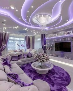 the living room is decorated in purple and white with chandeliers on the ceiling