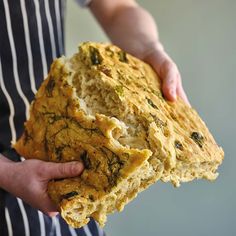 a person holding a loaf of bread in their hands