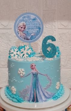 a frozen princess birthday cake with the number six on top