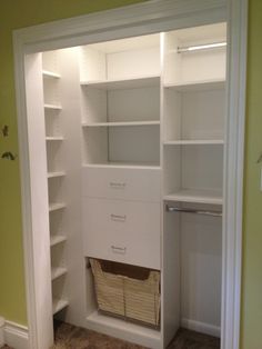 an empty closet with shelves and baskets in it