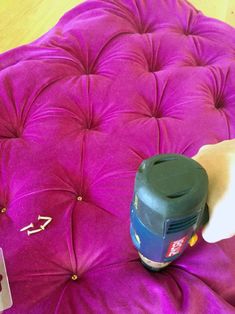 a purple ottoman with a black top on it