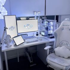 a desk with two computer monitors and a laptop on it, sitting in front of a white chair