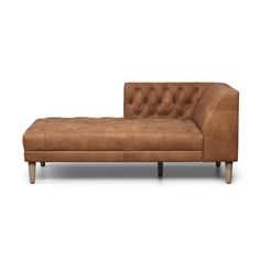 a brown leather chaise lounger with wooden legs and tufted upholster