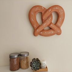 two pretzels are hanging on the wall next to some spices and spice jars