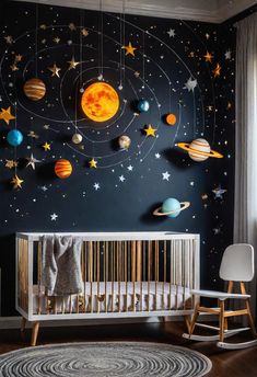 a baby's room with planets and stars on the wall