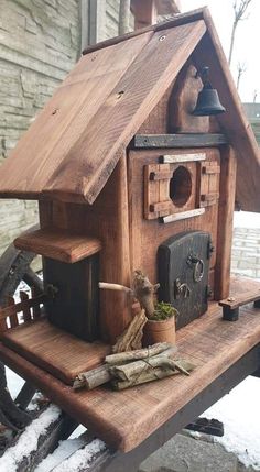 a bird house made out of wood on top of a table