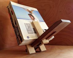 a stack of books sitting on top of a wooden stand