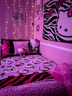 a bedroom decorated in pink and black with hello kitty bedding, wall decor and lights