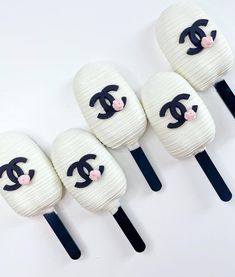 four marshmallows with black and white designs on them are lined up in a row