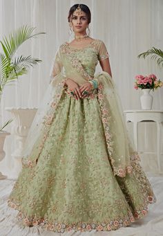 Net Lehenga in Light Green This Attire with Art Silk Lining is Enhanced with Resham, Zari, Sequins and Patch Border Work Available with a Semi-stitched Net Choli in Light Green, Crafted in Sweetheart Neck and Short Sleeves and a Scalloped Net Dupatta in Light Green. Choli Length is 14 to 15 inches and Sleeve Length is 4 to 5 inches This Semi-stitched Lehenga Waist and Hips are Customizable from 28 to 38 and 36 to 46 inches respectively. Its Length is 41 inches Do note: Accessories shown in the Green Lehenga Choli, Indian Bridesmaid Dresses, Sabyasachi Lehenga, Reception Lehenga, Party Wear Lehenga Choli, Bollywood Lehenga, Lehenga Wedding, Green Lehenga, Net Lehenga