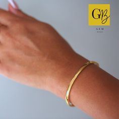 Introducing our Classic Gold Bracelet. This is a simple gold plated 14k hinged bangle which is a timeless piece. This trendy bracelet will bring a minimalist, modern and fashion touch to your look. Elegant and simple in its design and therefore such a favourite piece. Crafted from high-quality stainless steel, this bangle is built to last. The gold plating not only enhances its aesthetic appeal but also adds a luxurious touch, exuding a radiant glow that catches the eye. The combination of stain Minimalist Gold-plated Bracelet For Anniversary, Minimalist Gold Plated Bracelet For Anniversary, Minimalist Yellow Gold-plated Bangle, Minimalist Yellow Gold Plated Bangle, Gold Bangle Bracelet With Simple Design, Gold Simple Design Bangle Bracelet, Trendy Bracelet, Trendy Bracelets, Bangles Making