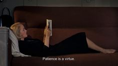 a woman laying on top of a brown couch next to a white box with the words patience is a virtual