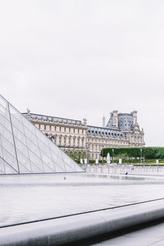 a large building with a pyramid in front of it