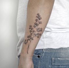 a person with a flower tattoo on their arm