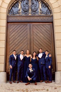 a group of people standing in front of a wooden door