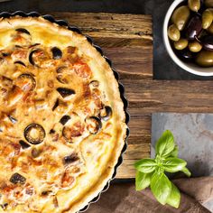 an image of a pie with olives on the side