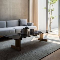 a living room with a couch, coffee table and sliding glass doors