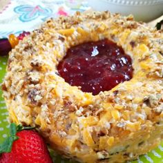 a close up of a doughnut on a plate with strawberries