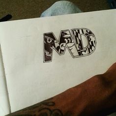 a hand holding a piece of paper with the word dad written on it in large letters