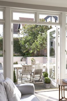 a living room filled with furniture next to a sliding glass door that opens onto a patio