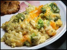 a white plate topped with macaroni and cheese covered in broccoli